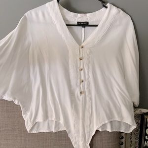 White blouse, bottom ties into a knot.
